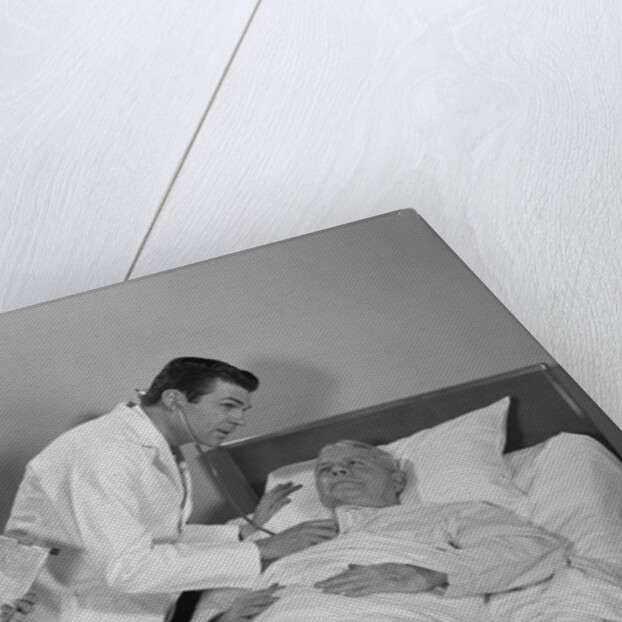 Doctor and nurse checking on elderly male patient in hospital bed by Anonymous