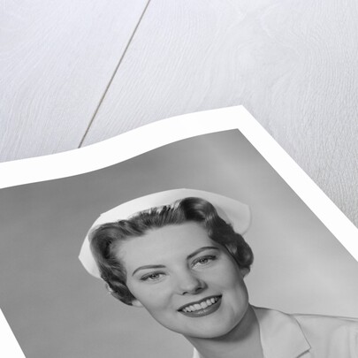 Portrait female nurse smiling by Anonymous