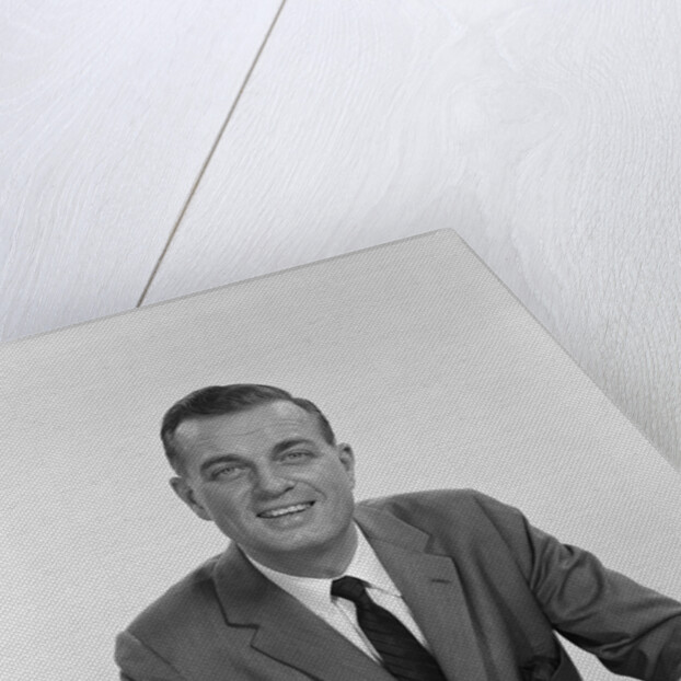 Smiling happy businessman pen in hand signing papers at desk by Anonymous