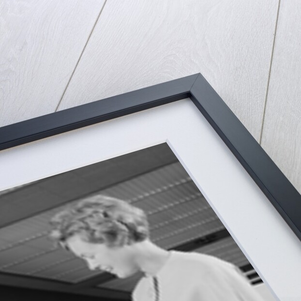 Mother two children boy handing banking deposit to male bank teller by Anonymous