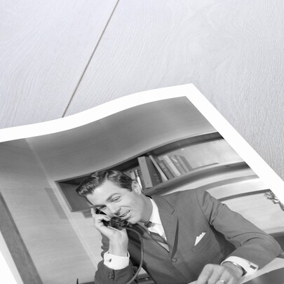 Businessman executive at desk talking on telephone by Anonymous