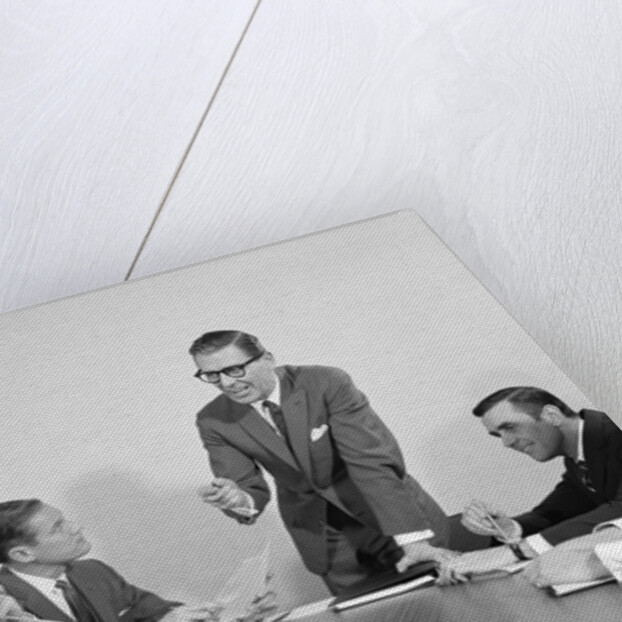 5 executive businessmen meeting at conference table one man standing by Anonymous