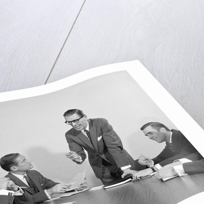 5 executive businessmen meeting at conference table one man standing by Anonymous