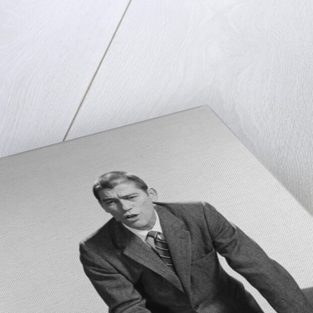 Angry upset businessman pounding fist into desk by Anonymous