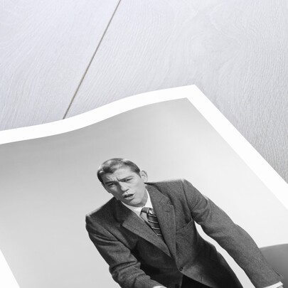 Angry upset businessman pounding fist into desk by Anonymous