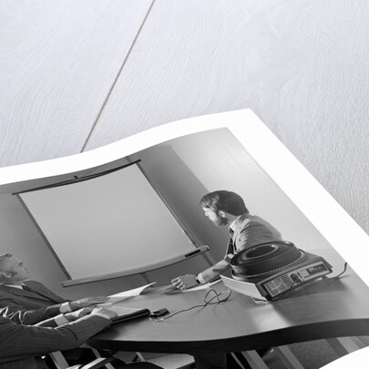 Three executive businessmen conference table audiovisual presentation by Anonymous