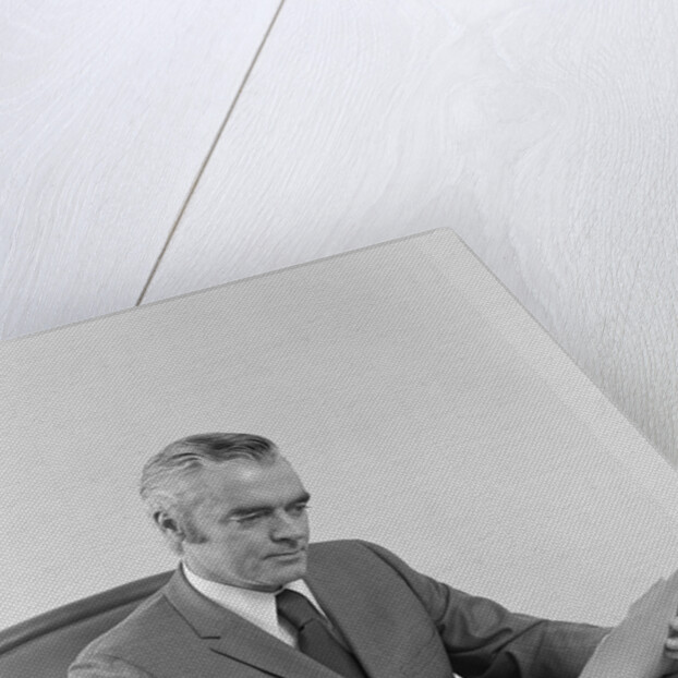 Businessman executive middle aged sitting at desk reading papers by Anonymous