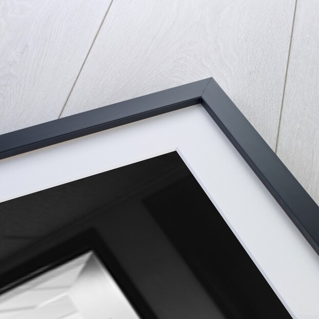 Executive businessman at desk seen working late through door ajar by Anonymous