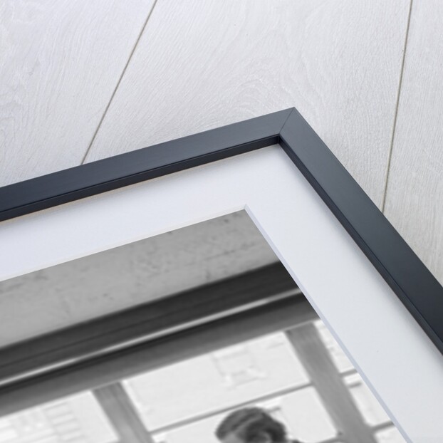 Two men one seated shaking hands long wooden conference table by Anonymous