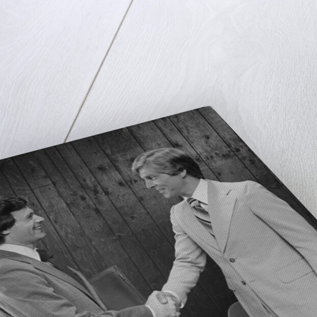 Two businessmen shaking hands handshake by Anonymous