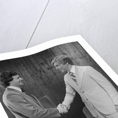 Two businessmen shaking hands handshake by Anonymous