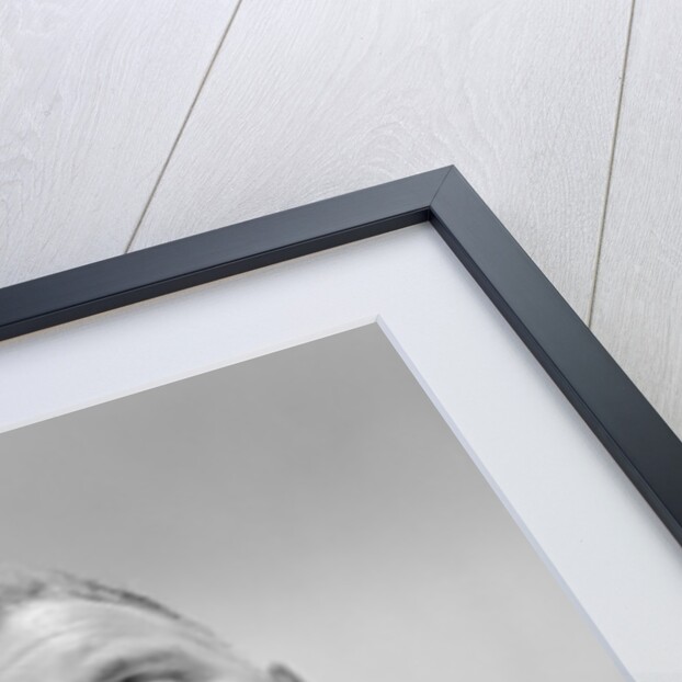 Serious thinking thoughtful older man holding eyeglasses to chin by Anonymous