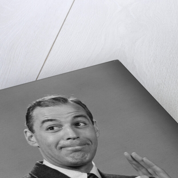 Man punching his fist into his palm with satisfied expression by Anonymous