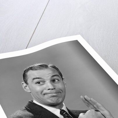 Man punching his fist into his palm with satisfied expression by Anonymous