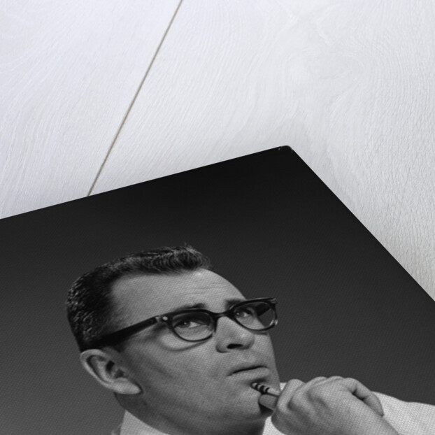 Man thinking hand pencil on chin wearing eyeglasses serious expression by Anonymous