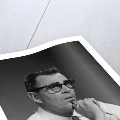 Man thinking hand pencil on chin wearing eyeglasses serious expression by Anonymous