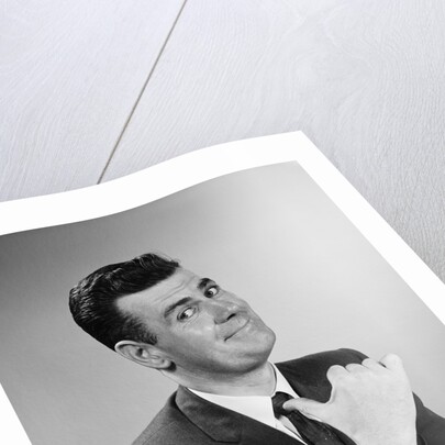 Business man smiling giving thumbs up sign pointing to himself by Anonymous