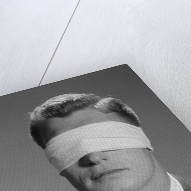 Young man wearing blindfold by Anonymous