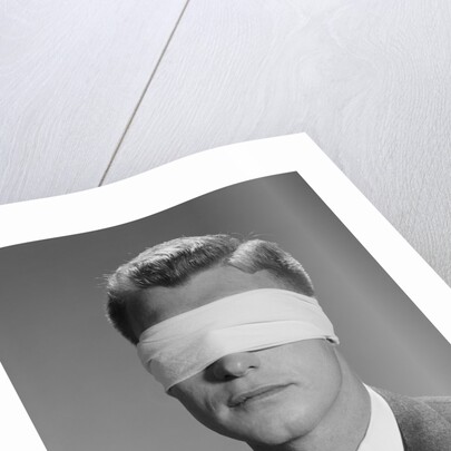 Young man wearing blindfold by Anonymous
