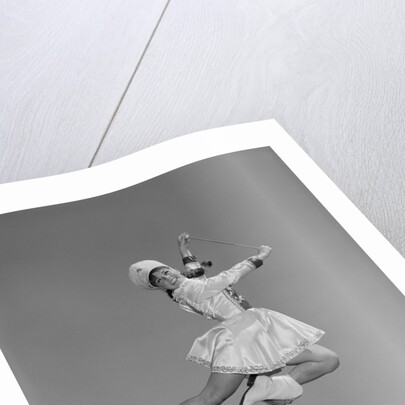 Woman majorette wearing band uniform holding baton jumping into the air by Anonymous