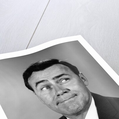 Businessman making funny face looking to the side by Anonymous