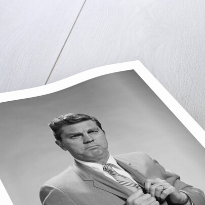 Portrait middle aged man stern serious expression hands gripping his lapels by Anonymous