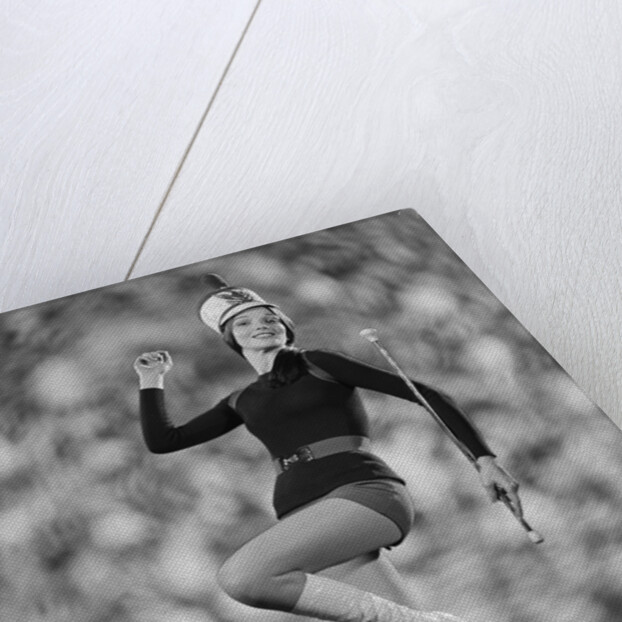 Smiling young woman majorette white boots hot pants marching by Anonymous