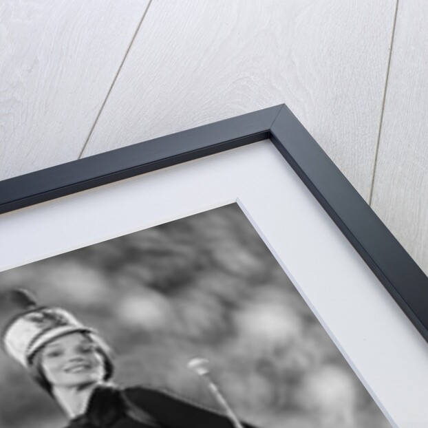 Smiling young woman majorette white boots hot pants marching by Anonymous