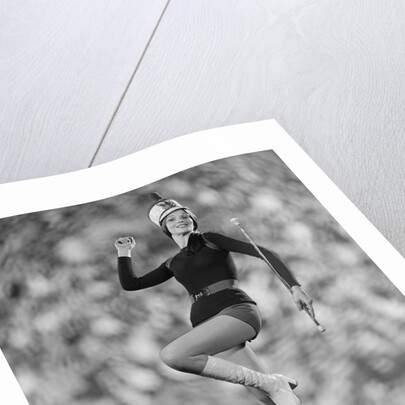 Smiling young woman majorette white boots hot pants marching by Anonymous