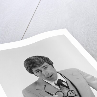 Businessman serious expression pointing with eyeglasses by Anonymous