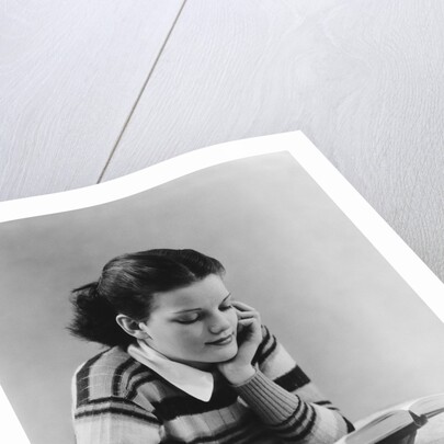 Young brunette woman teen striped sweater reading book studying by Anonymous