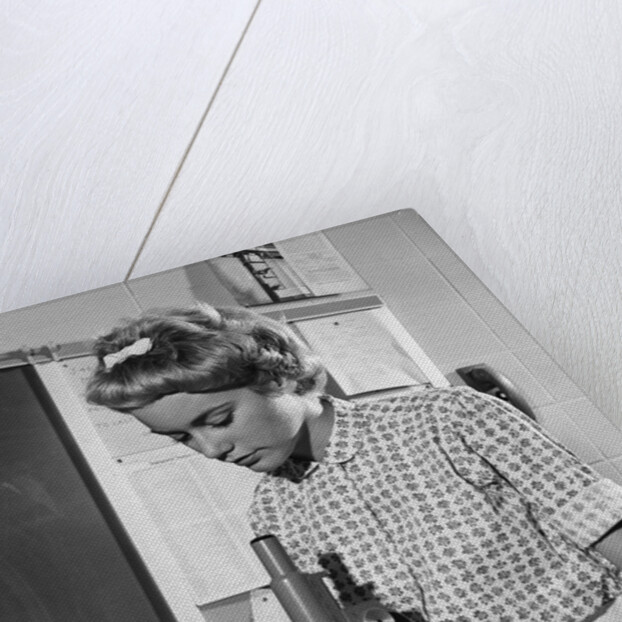 Teen girl writing notes working with microscope in science classroom by Anonymous