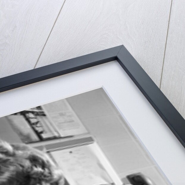 Teen girl writing notes working with microscope in science classroom by Anonymous