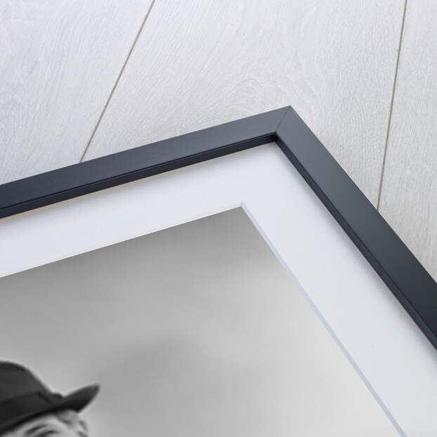 Smiling man carrying shopping boxes wearing hat coat gloves by Anonymous