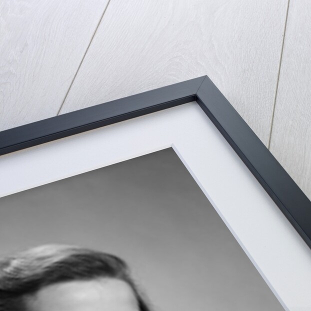 Young smiling woman holding books looking at camera by Anonymous