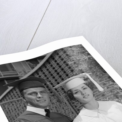 Graduation couple in cap and gown by Anonymous