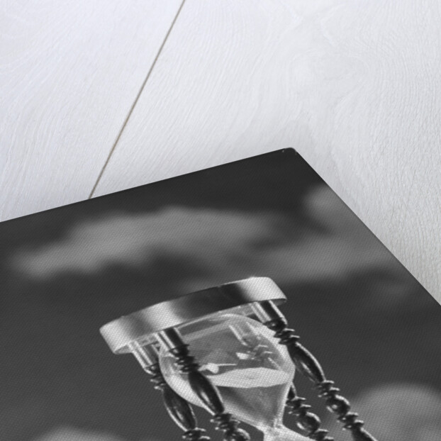 Hourglass against background of clouds by Anonymous
