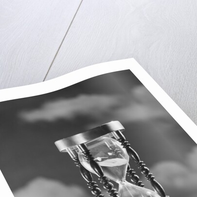 Hourglass against background of clouds by Anonymous
