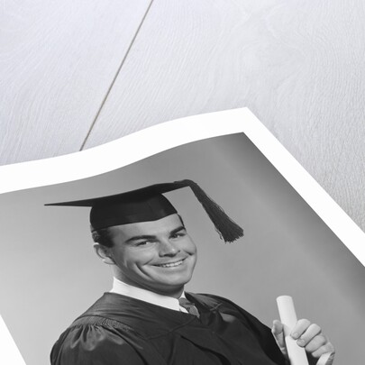 Smiling man holding diploma wearing graduation robes by Anonymous