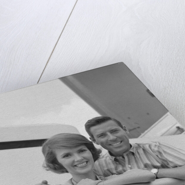 Portrait smiling couple standing by shipboard rail by Anonymous