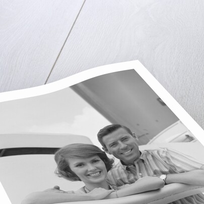 Portrait smiling couple standing by shipboard rail by Anonymous
