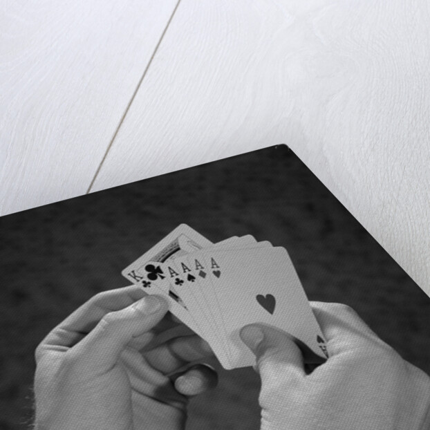 Male hands holding hand poker cards 4 aces and a king by Anonymous