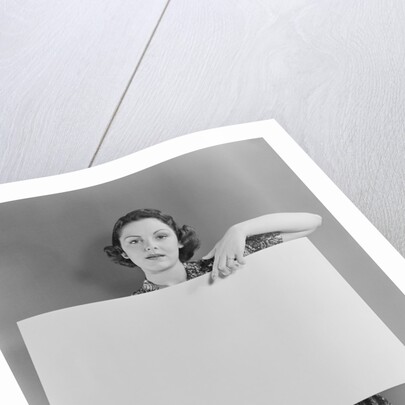 Woman holding blank poster sign hand pointing from top by Anonymous