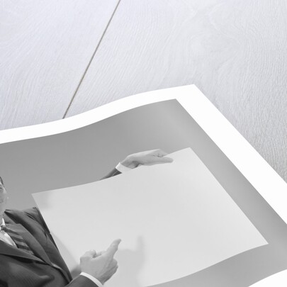 Smiling man pointing to blank poster by Anonymous