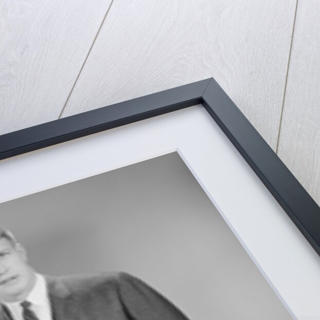 Man standing beside blank screen ready for presentation by Anonymous