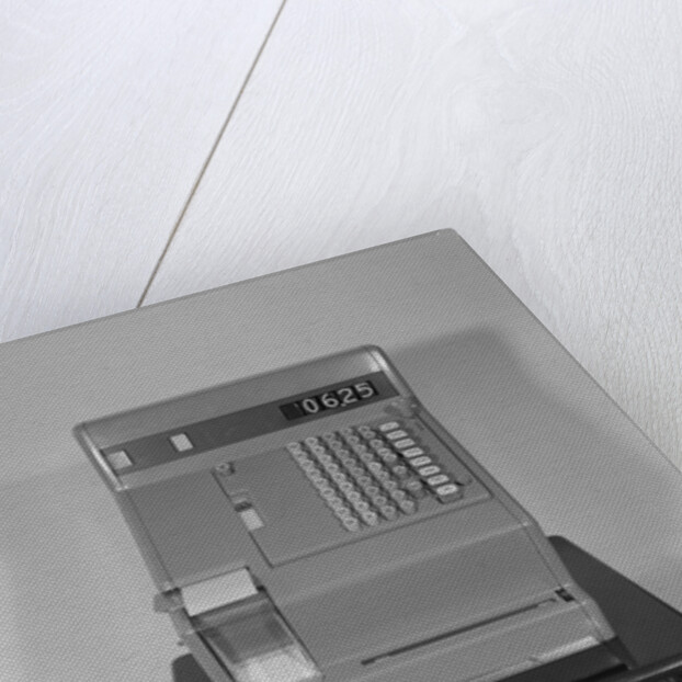 Cash register with money in the open till drawer by Anonymous