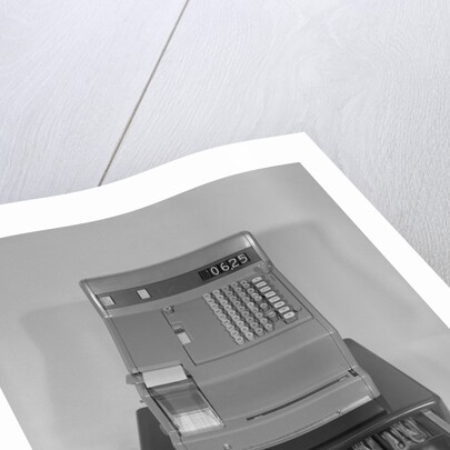 Cash register with money in the open till drawer by Anonymous