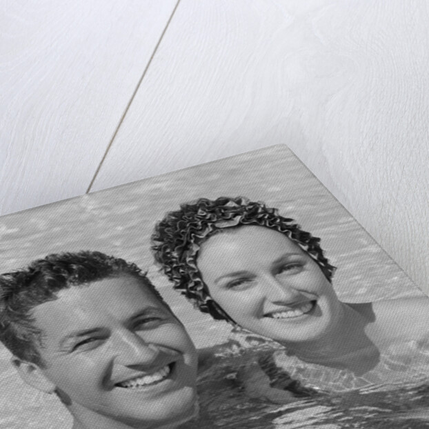 Smiling couple man woman in swimming pool by Anonymous