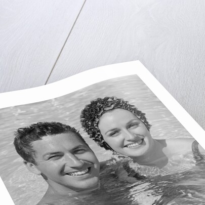 Smiling couple man woman in swimming pool by Anonymous