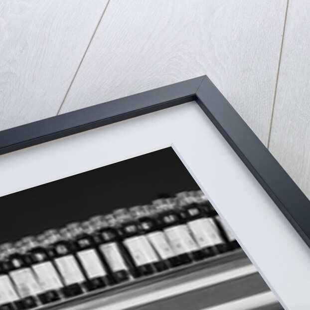 Blond woman selecting ice cream frozen food section supermarket by Anonymous